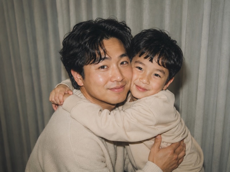 A man hugging his younger self.
