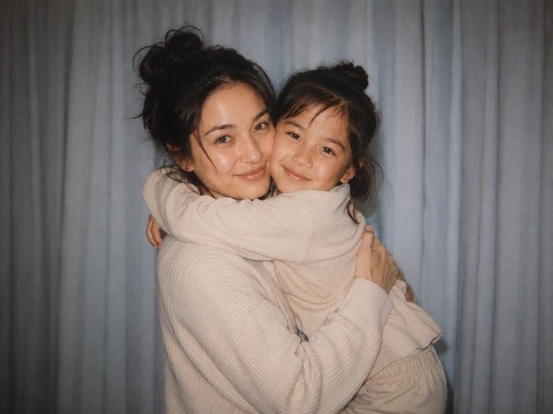 An adult holding their younger self.