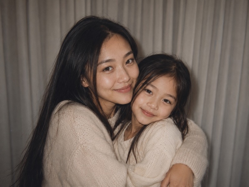 An adult hugging their childhood self.
